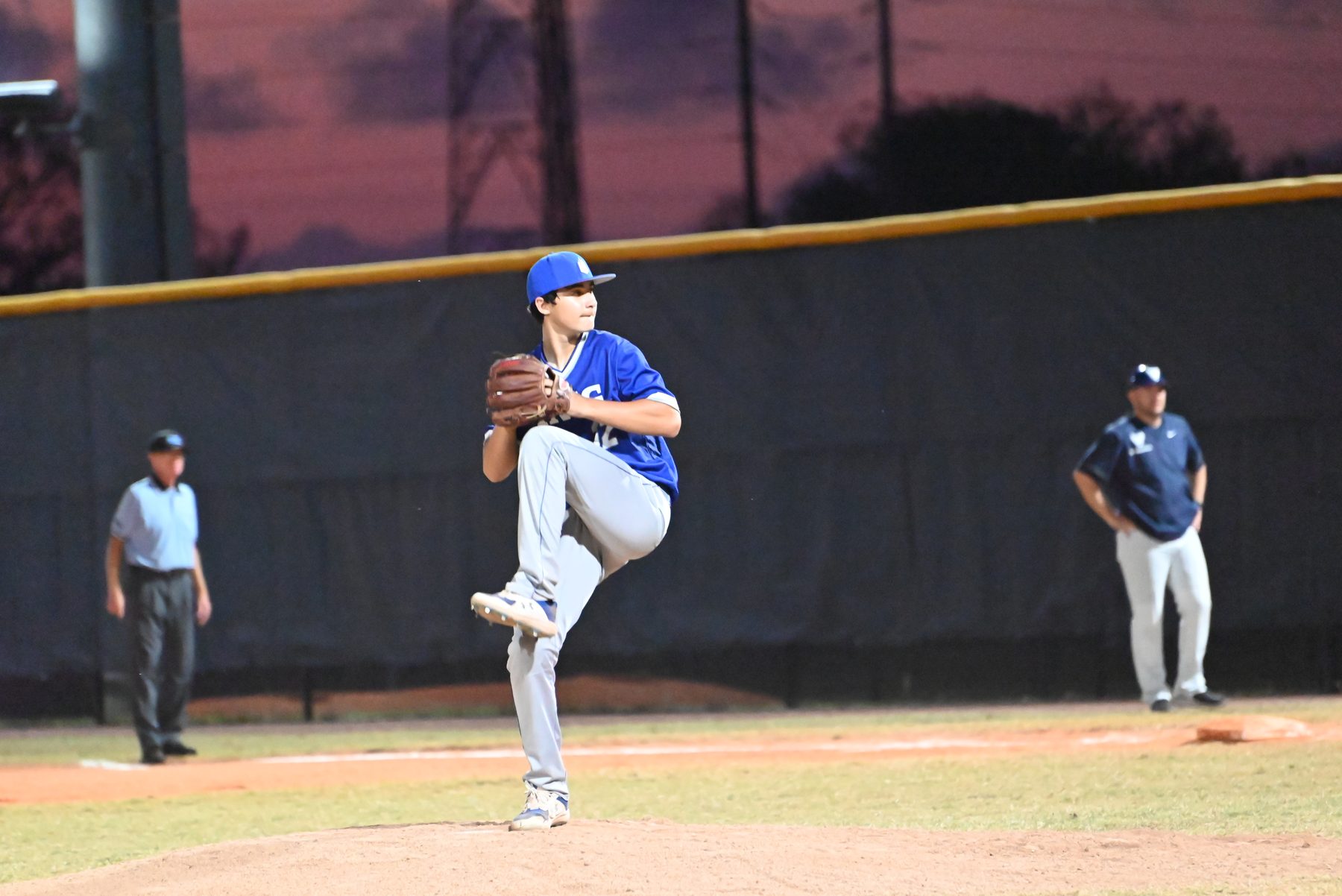 Pitcher at the top of his leg lift under the lights