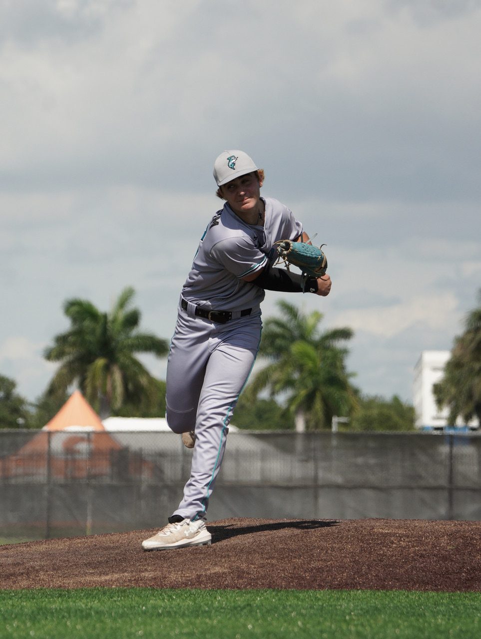 Pitcher driving down the mound toward the plate